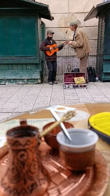 Bosnian coffee in a copper džezva at Caffe Bar Andar, with street musicians on Baščaršija